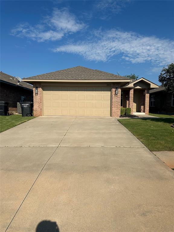 3600 Green Apple Pl, Moore, OK 73160 - view of front of house featuring driveway, an attached garage, a front lawn, and brick siding
