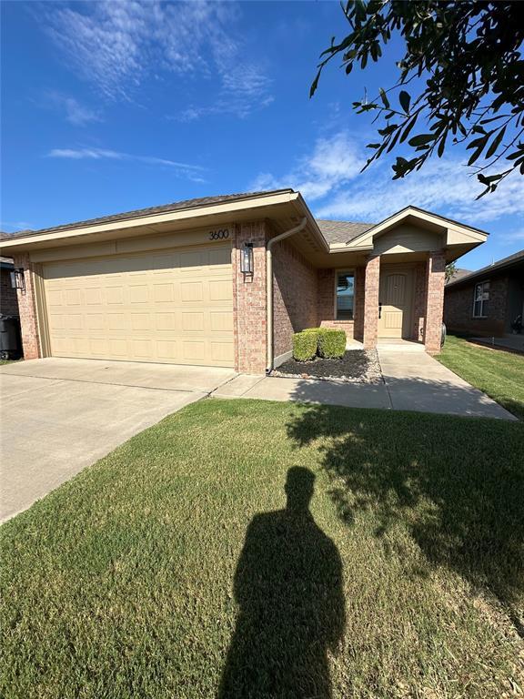 3600 Green Apple Pl, Moore, OK 73160 - single story home with brick siding, a garage, a front lawn, and concrete driveway