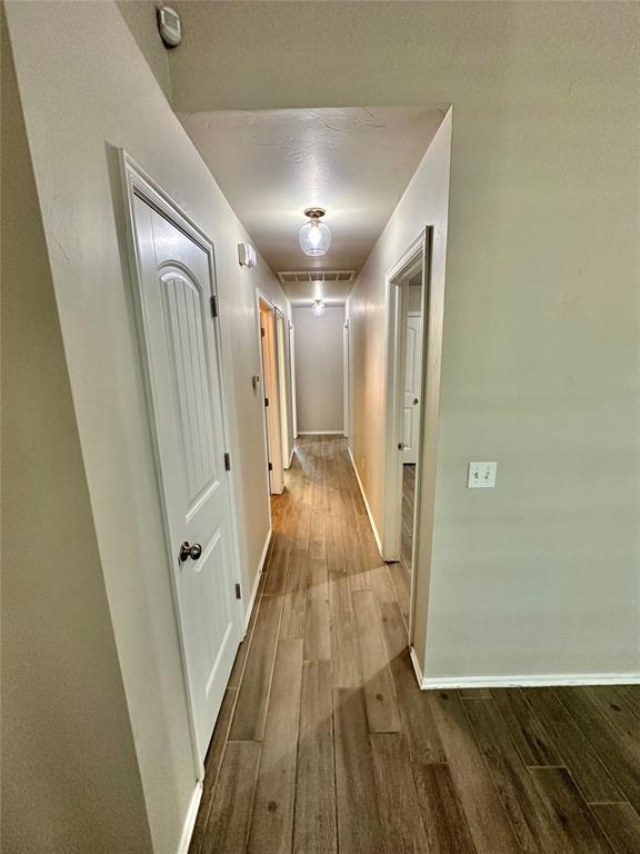 3600 Green Apple Pl, Moore, OK 73160 - corridor featuring dark wood-style flooring