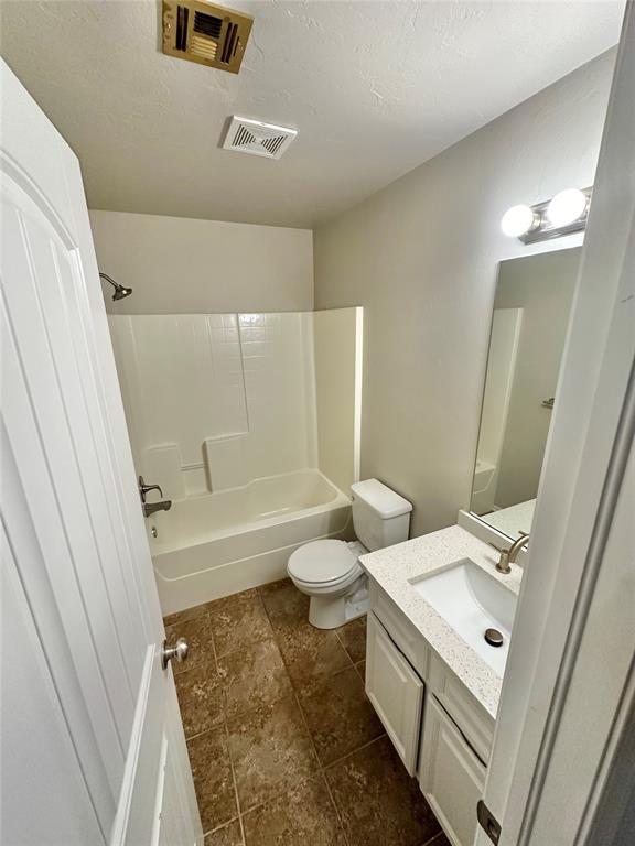 3600 Green Apple Pl, Moore, OK 73160 - bathroom with vanity, shower / bathtub combination, and a textured ceiling