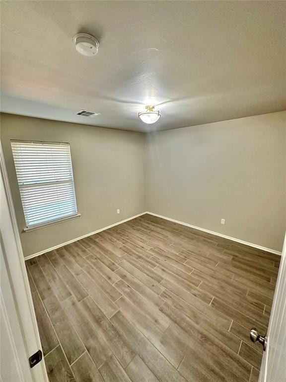 3600 Green Apple Pl, Moore, OK 73160 - unfurnished room with dark wood-style flooring and a smoke detector