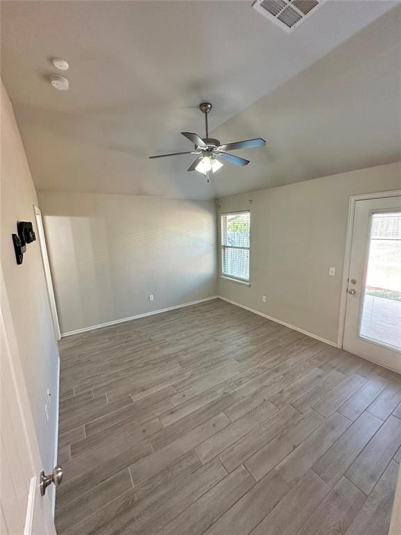 3600 Green Apple Pl, Moore, OK 73160 - spare room featuring wood finished floors, ceiling fan, and lofted ceiling