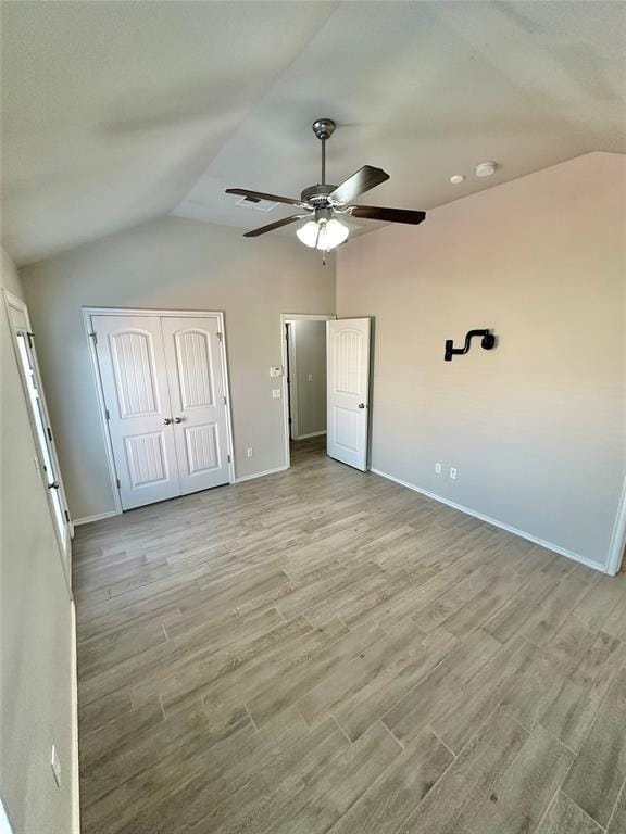 3600 Green Apple Pl, Moore, OK 73160 - unfurnished bedroom featuring vaulted ceiling, wood finished floors, a closet, and ceiling fan