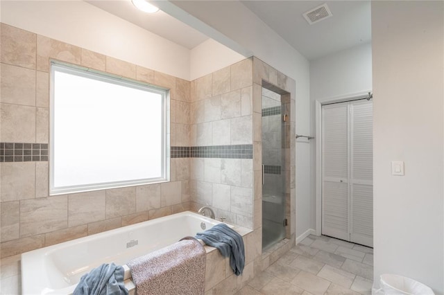 3356 E Maple Rd, Purcell, OK 73080 - full bathroom featuring a bath, a closet, and a stall shower