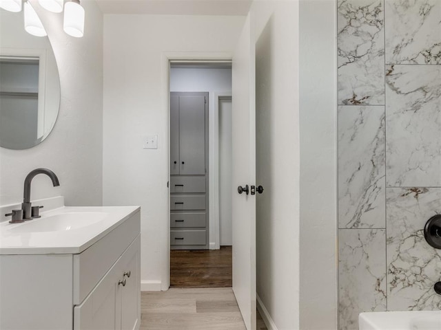 1420 SW 67th St, Oklahoma City, OK 73159 - bathroom with vanity, wood finished floors, and tub / shower combination