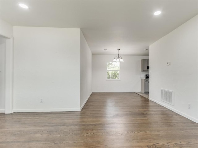 1420 SW 67th St, Oklahoma City, OK 73159 - spare room with a chandelier, dark wood-style floors, and recessed lighting