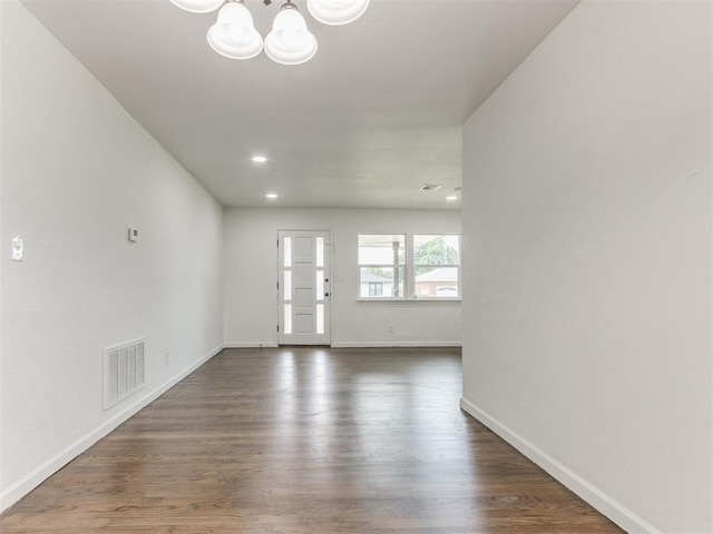 1420 SW 67th St, Oklahoma City, OK 73159 - unfurnished living room featuring a chandelier, dark wood-style flooring, and recessed lighting