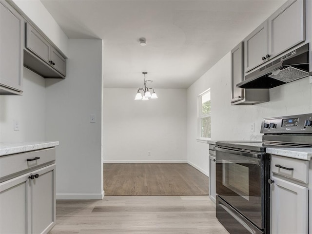 1420 SW 67th St, Oklahoma City, OK 73159 - kitchen with under cabinet range hood, black electric range, gray cabinets, a chandelier, and light wood finished floors