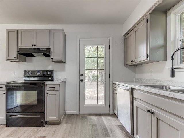 1420 SW 67th St, Oklahoma City, OK 73159 - kitchen with under cabinet range hood, black range with electric stovetop, and gray cabinetry