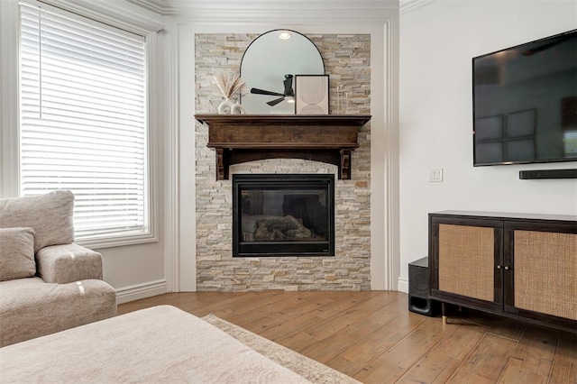 15728 Egerton Pl, Edmond, OK 73013 - living area with wood finished floors, a fireplace, and ceiling fan