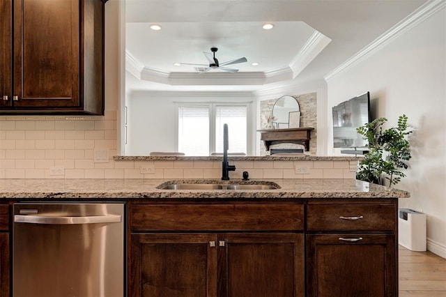 15728 Egerton Pl, Edmond, OK 73013 - kitchen featuring dishwasher, ceiling fan, dark brown cabinetry, a tray ceiling, and decorative backsplash