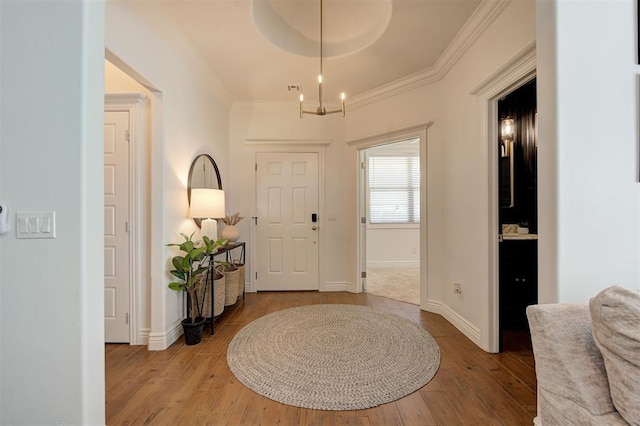 15728 Egerton Pl, Edmond, OK 73013 - entrance foyer with wood finished floors, crown molding, and a chandelier