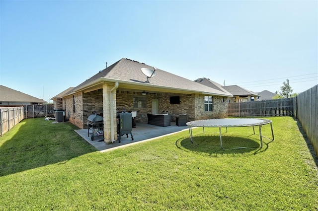15728 Egerton Pl, Edmond, OK 73013 - back of house featuring brick siding, a fenced backyard, ceiling fan, and a patio