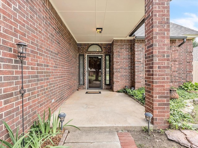 18317 Chestnut Oak Dr, Edmond, OK 73012 - entrance to property with roof with shingles and brick siding