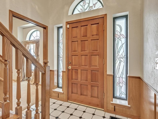 18317 Chestnut Oak Dr, Edmond, OK 73012 - entrance foyer featuring wainscoting, stairway, and tile patterned floors