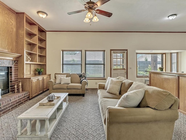 18317 Chestnut Oak Dr, Edmond, OK 73012 - carpeted living room featuring a ceiling fan, a fireplace, and built in shelves