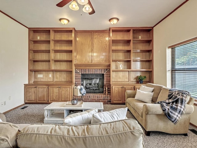 18317 Chestnut Oak Dr, Edmond, OK 73012 - living area with carpet, a fireplace, ceiling fan, ornamental molding, and built in features