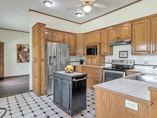 18317 Chestnut Oak Dr, Edmond, OK 73012 - kitchen with appliances with stainless steel finishes, light flooring, tile counters, under cabinet range hood, and ceiling fan