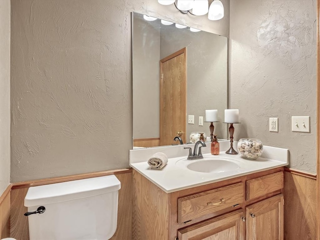 18317 Chestnut Oak Dr, Edmond, OK 73012 - half bathroom featuring vanity and a wainscoted wall