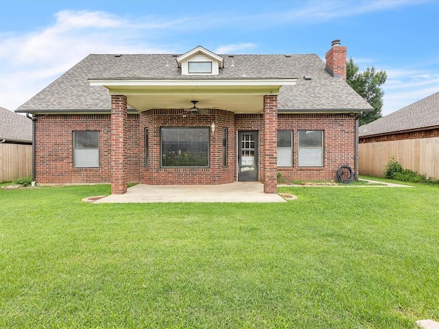 18317 Chestnut Oak Dr, Edmond, OK 73012 - rear view of house featuring a shingled roof, a patio area, brick siding, and a chimney