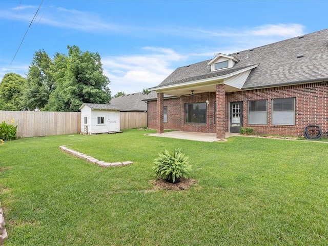 18317 Chestnut Oak Dr, Edmond, OK 73012 - fenced backyard with a patio area, a storage shed, and a ceiling fan