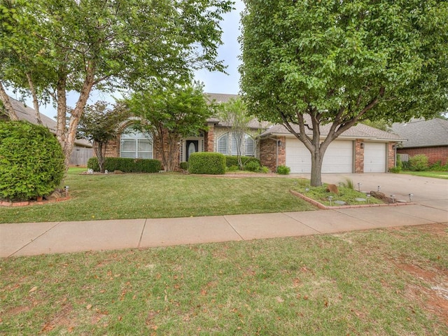 1340 NW 168th St, Edmond, OK 73012 - obstructed view of property with driveway, brick siding, a front lawn, and an attached garage
