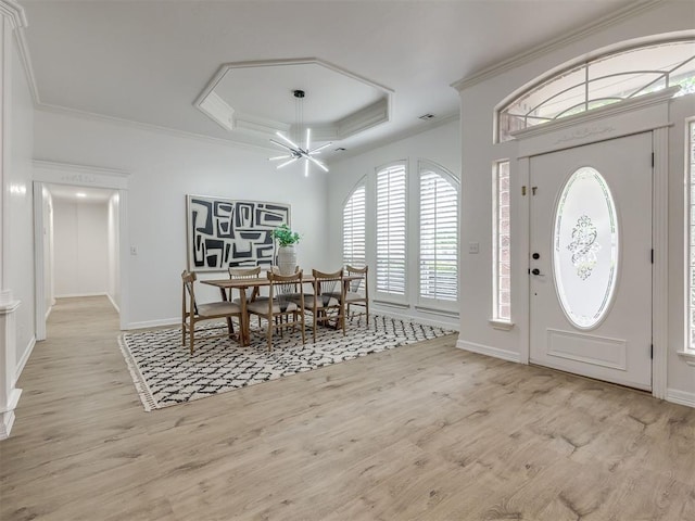 1340 NW 168th St, Edmond, OK 73012 - entrance foyer with a tray ceiling, crown molding, light wood finished floors, and a chandelier