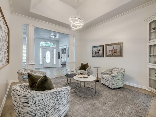 1340 NW 168th St, Edmond, OK 73012 - living area featuring ornate columns, wood finished floors, crown molding, and a chandelier