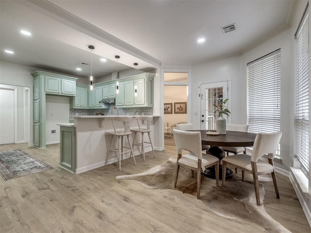 1340 NW 168th St, Edmond, OK 73012 - dining room with crown molding, light wood-style flooring, and recessed lighting