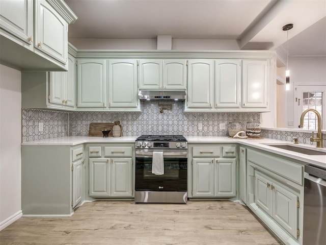 1340 NW 168th St, Edmond, OK 73012 - kitchen featuring stainless steel appliances, under cabinet range hood, light countertops, and decorative backsplash