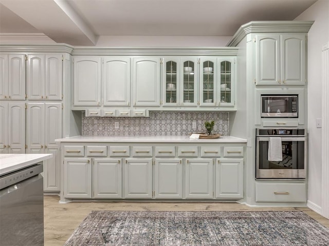 1340 NW 168th St, Edmond, OK 73012 - kitchen featuring appliances with stainless steel finishes, decorative backsplash, and light countertops