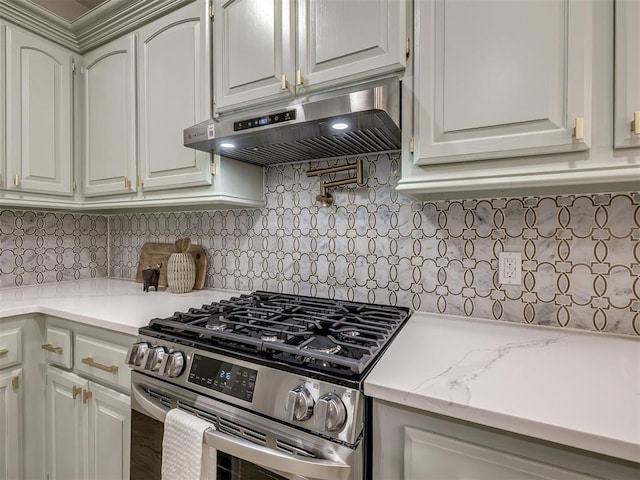 1340 NW 168th St, Edmond, OK 73012 - kitchen featuring stainless steel gas range, under cabinet range hood, decorative backsplash, white cabinets, and light stone counters