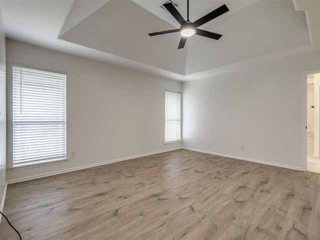 1340 NW 168th St, Edmond, OK 73012 - unfurnished room with a tray ceiling, ceiling fan, and wood finished floors
