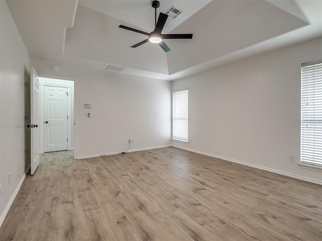 1340 NW 168th St, Edmond, OK 73012 - empty room with ceiling fan, light wood-style flooring, and a tray ceiling