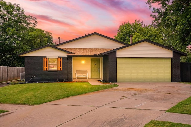 3300 Outpost Cir, Norman, OK 73072 - view of front facade featuring driveway, an attached garage, and brick siding