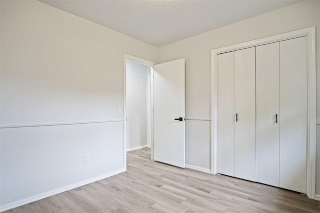 3300 Outpost Cir, Norman, OK 73072 - unfurnished bedroom featuring light wood-style floors and a closet