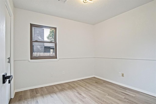 3300 Outpost Cir, Norman, OK 73072 - unfurnished room with wood finished floors and a textured ceiling