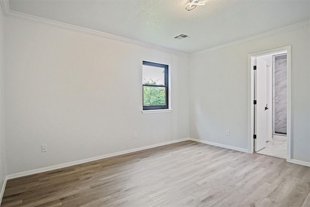3300 Outpost Cir, Norman, OK 73072 - unfurnished room with light wood-style floors, ornamental molding, and a textured ceiling