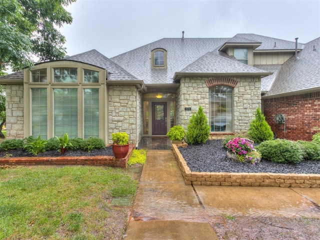 123 E Lakeview Trl, Edmond, OK 73003 - french country style house with stone siding and roof with shingles