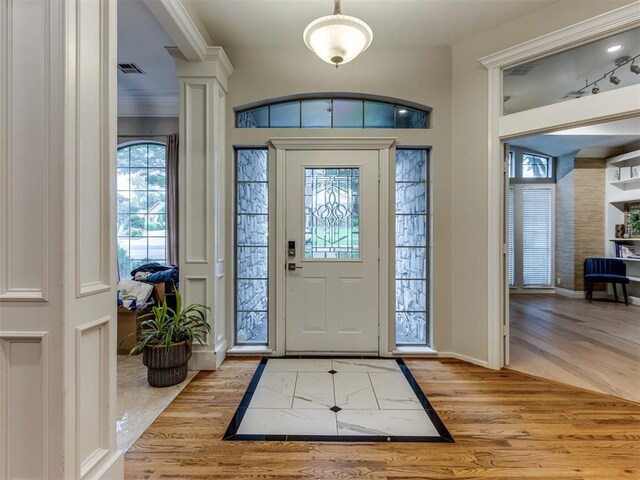 123 E Lakeview Trl, Edmond, OK 73003 - foyer with light wood finished floors and crown molding