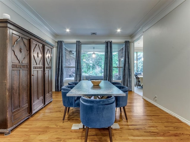 123 E Lakeview Trl, Edmond, OK 73003 - dining room featuring crown molding and light wood-style flooring