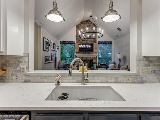 123 E Lakeview Trl, Edmond, OK 73003 - kitchen featuring lofted ceiling, a chandelier, backsplash, light stone counters, and white cabinets