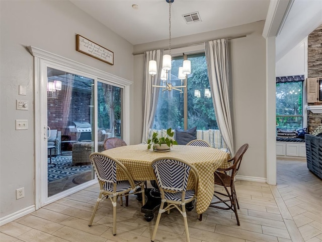 123 E Lakeview Trl, Edmond, OK 73003 - dining area featuring light wood finished floors and a chandelier