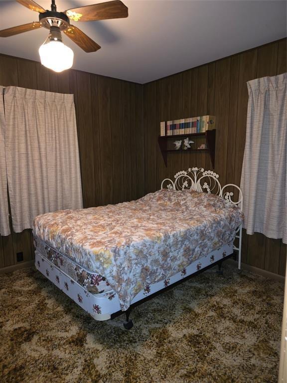 730 N Santa Fe St Unit 4052073333, Pauls Valley, OK 73075 - bedroom with carpet floors, wooden walls, and ceiling fan