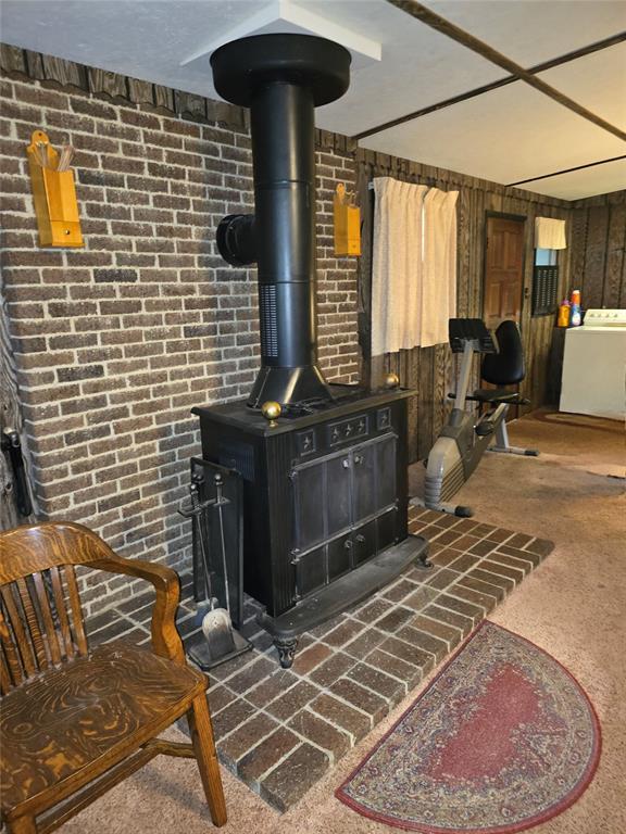 730 N Santa Fe St Unit 4052073333, Pauls Valley, OK 73075 - detailed view of washer / clothes dryer, a wood stove, and brick wall