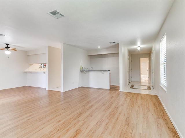 4400 Hemingway Dr Unit 221, Oklahoma City, OK 73118 - unfurnished living room with ceiling fan and light wood finished floors