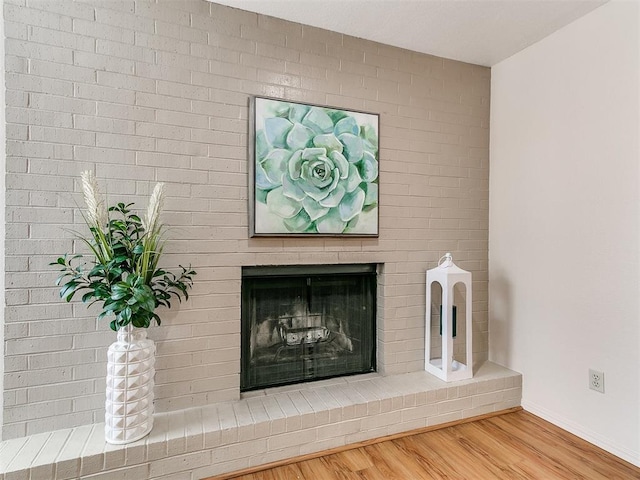 4400 Hemingway Dr Unit 221, Oklahoma City, OK 73118 - detailed view of wood finished floors and a brick fireplace