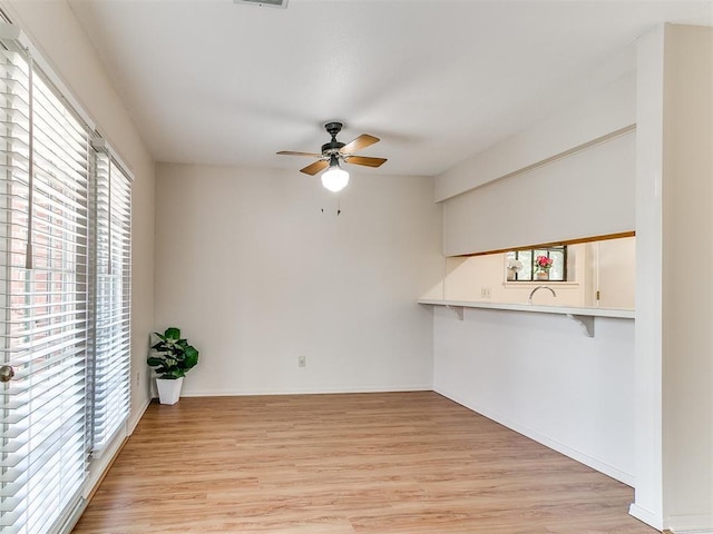 4400 Hemingway Dr Unit 221, Oklahoma City, OK 73118 - unfurnished living room with a ceiling fan and light wood-style floors