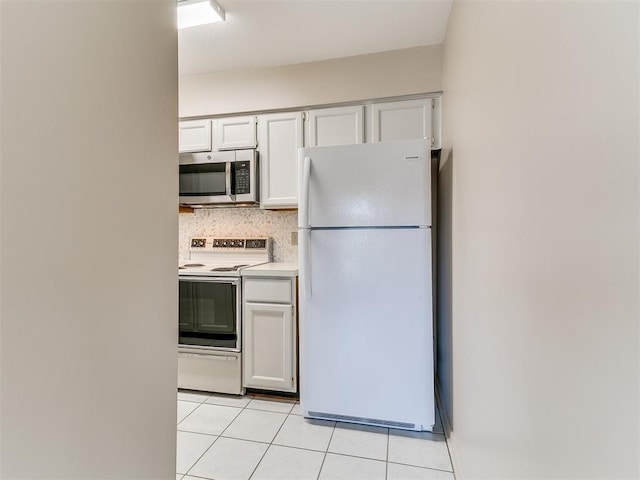 4400 Hemingway Dr Unit 221, Oklahoma City, OK 73118 - kitchen featuring white appliances, light tile patterned flooring, backsplash, white cabinetry, and light countertops