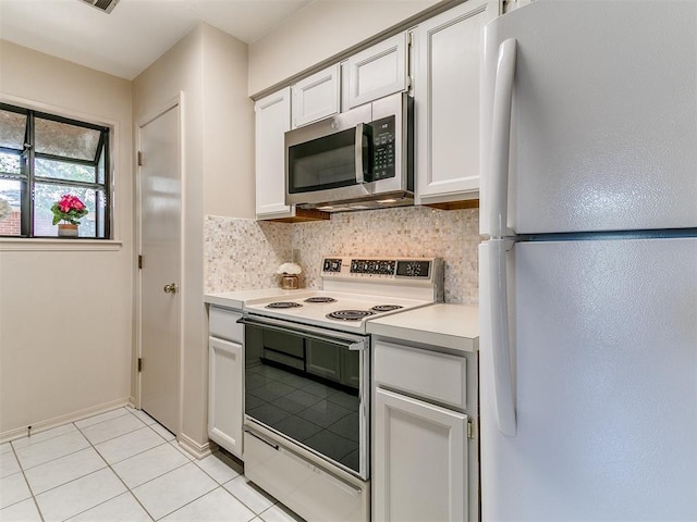 4400 Hemingway Dr Unit 221, Oklahoma City, OK 73118 - kitchen with white appliances, tasteful backsplash, light countertops, light tile patterned floors, and white cabinets